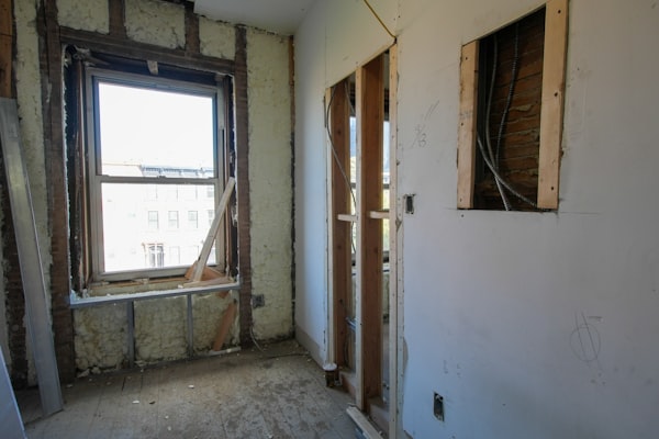 Interior room undergoing demolition with exposed walls